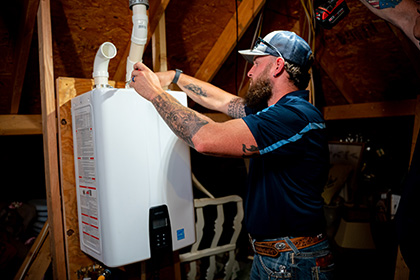 tech inspecting water heater in plano