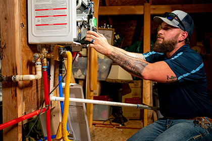 plumber performing water heater maintenance in plano tx